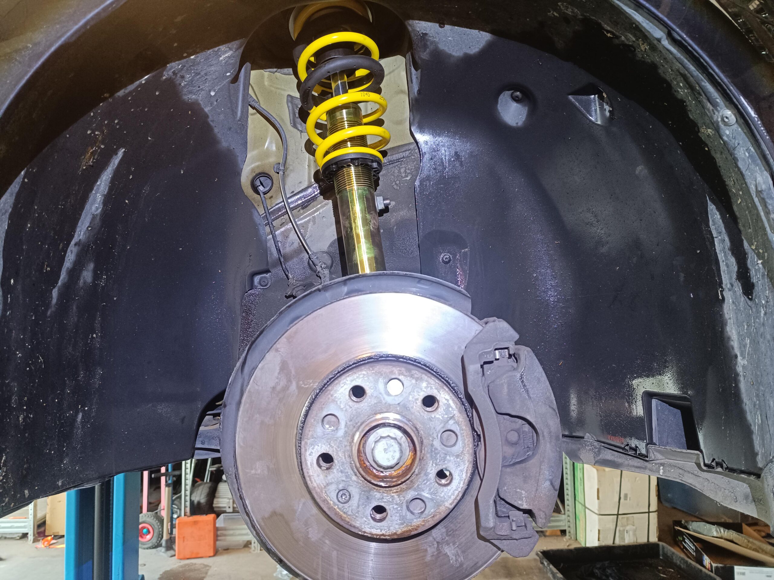 a car with a yellow shock absorber